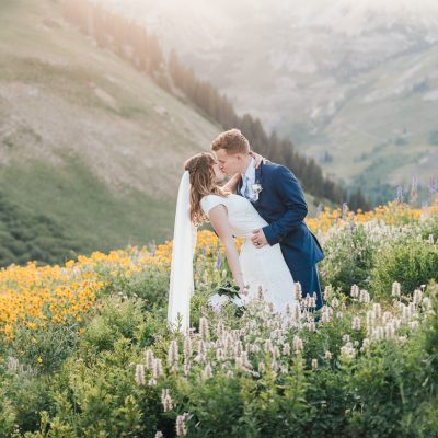 Bride and Groom in the mountains with wildflowers